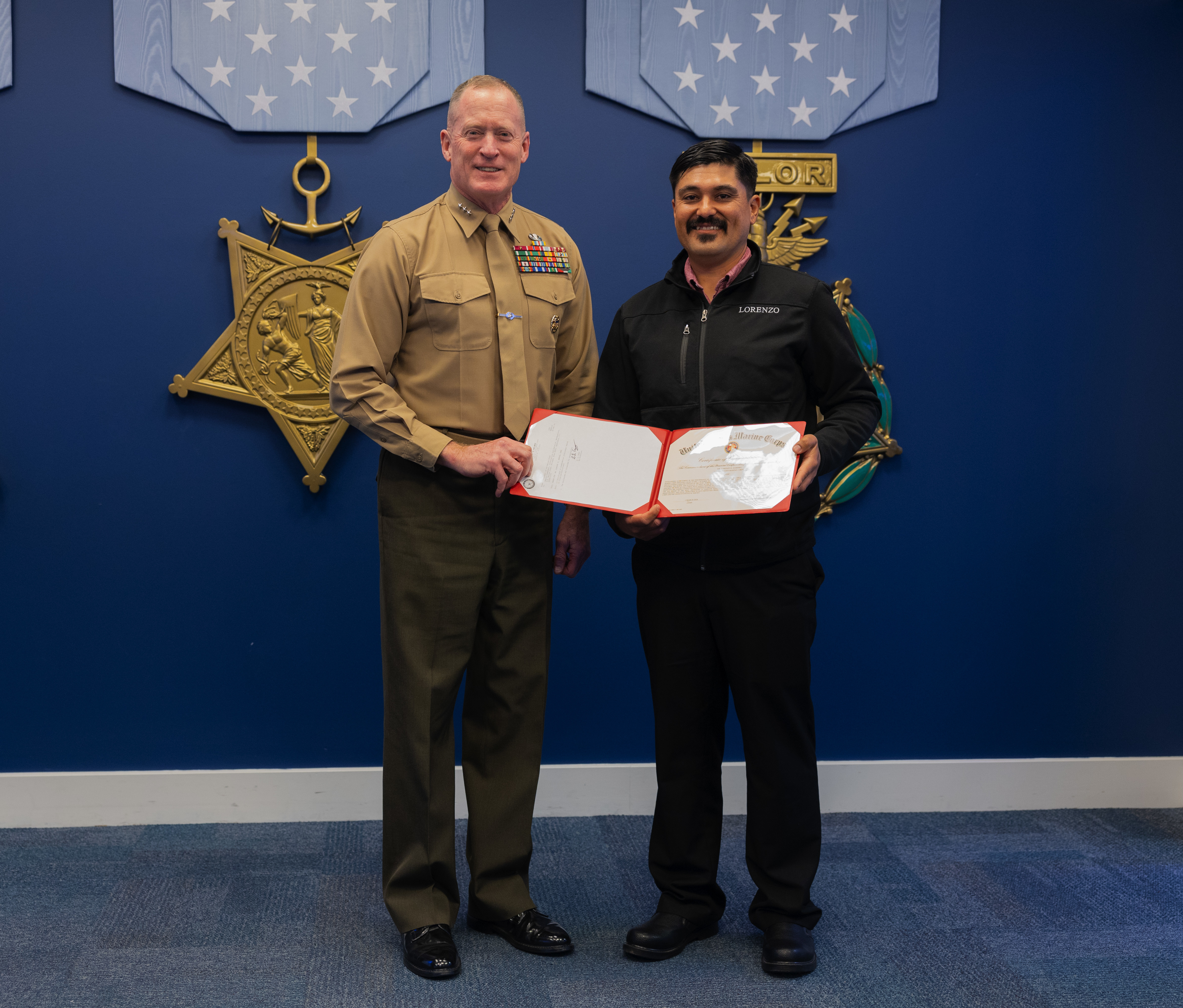 U.S. Marine Corps Lt. Gen. Edward Banta, the Deputy Commandant of Installations & Logistics, presents a certificate to Mr. Lorenzo Zamora, the animal caretaker for Marine Corps Logistics Base Barstow, at the Pentagon, Washington, D.C. on March 6, 2024. Zamora received the Marine Corps Installations Command Civilian of the Year award. (U.S. Marine Corps photo by Lance Cpl. Juaquin Greaves)