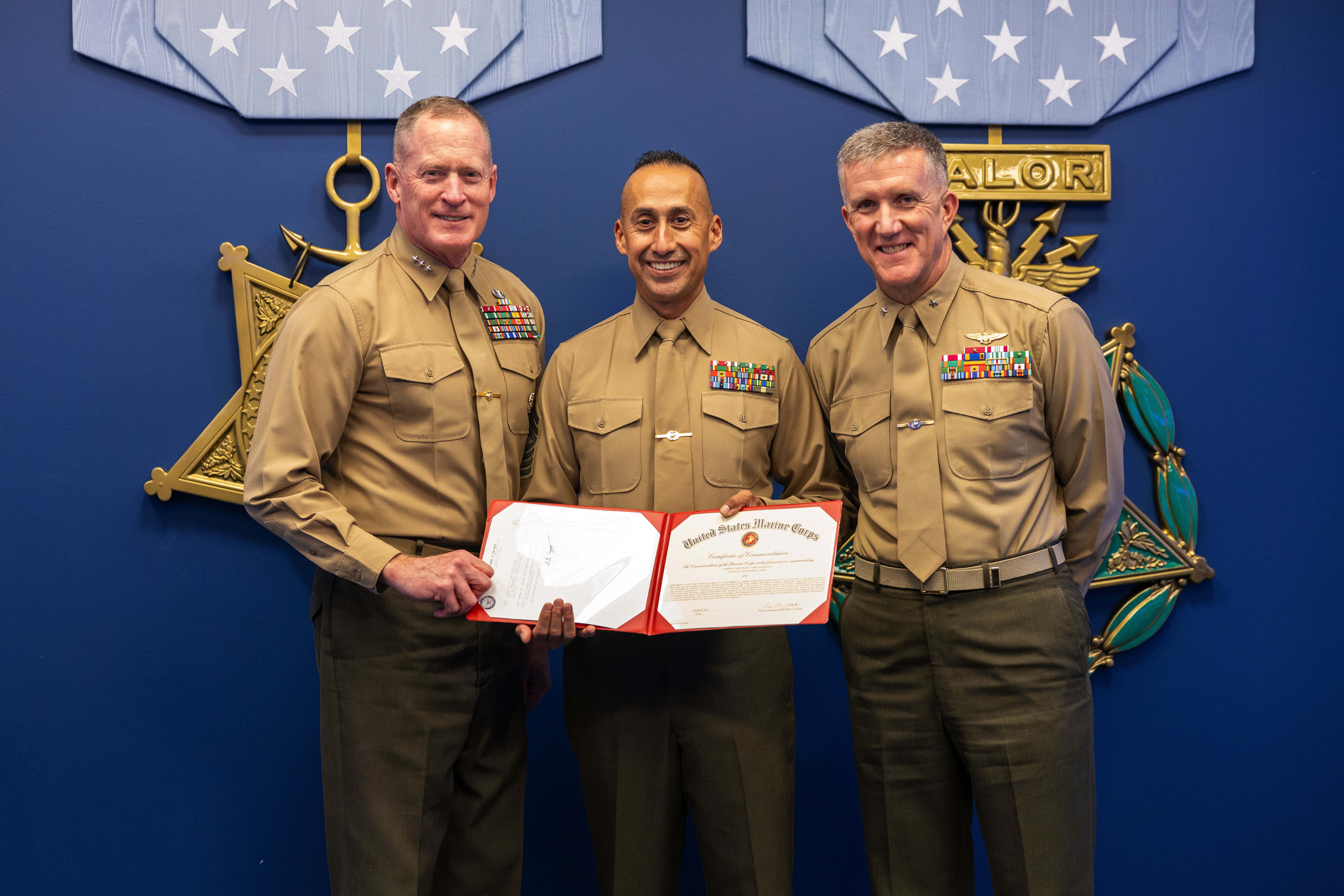 U.S. Marine Corps Lt. Gen. Edward Banta (left), the Deputy Commandant for Installations & Logistics presents a certificate to Sgt. Maj. Fausto Cabrera (center), sergeant major for Marine Corps Installations West- Marine Corps Base Camp Pendleton, and Brig. Gen. Jason G. Woodworth (right), commanding general for Marine Corps Installations West- Marine Corps Base Camp Pendleton, at the Pentagon, Washington, D.C. on March 6, 2024. Marine Corps Base Camp Pendleton, CA received the Marine Corps Installation Excellence Award the Ground Installation of the Year award. (U.S. Marine Corps photo by Lance Cpl. Juaquin Greaves)