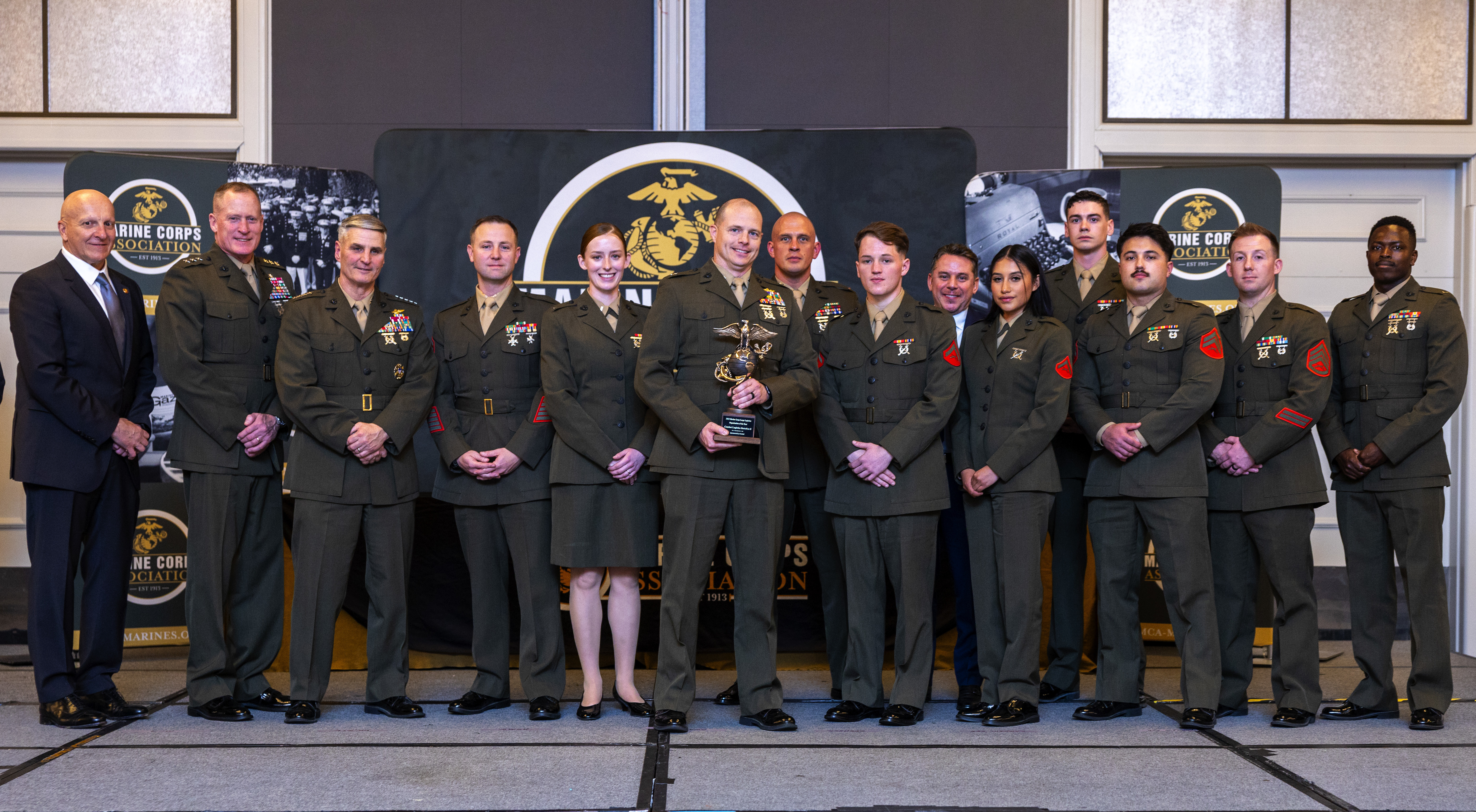 U.S. Marine Corps Gen. Christopher J. Mahoney, the Assistant Commandant of the Marine Corps, and Lt. Gen. Edward Banta, the Deputy Commandant of Installations and Logistics (left), stand with Marines from Combat Logistics Battalion 8, Marine Corps Base Camp Lejeune, at the Hilton Alexandria Mark Center, Alexandria, VA on March 6, 2024. The unit received the Large Unit Logistics Organization of the Year award. (U.S. Marine Corps photo by Lance Cpl. Juaquin Greaves)