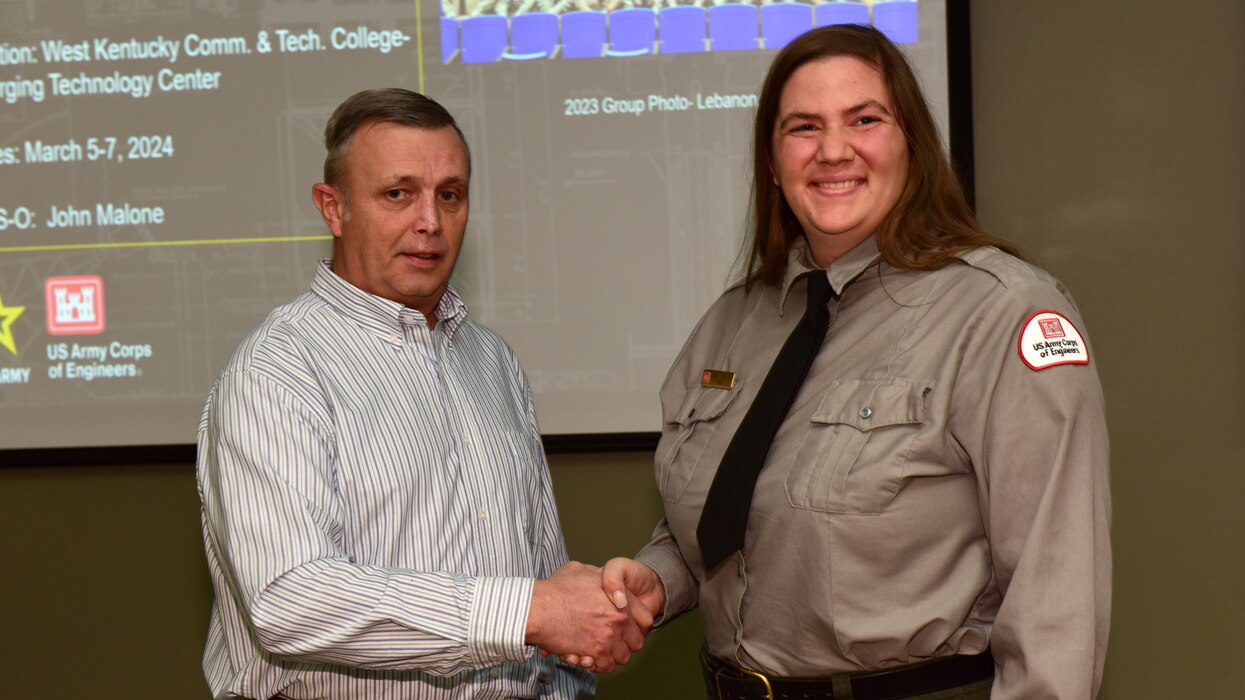 Tim Dunn, U.S. Army Corps of Engineers Nashville District Operations Division deputy chief, presents the Great Lakes and Ohio River Division Water Safety Award March 5, 2024, to Old Hickory Lake Park Ranger Gabby Fontaine at the Nashville District's Park Ranger Workshop in Paducah, Kentucky. Fontaine is lauded for her promotion of water safety to visitors, school groups, and nearby communities during the 2023 recreation season. (USACE Photo by Lee Roberts)