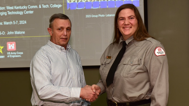 Tim Dunn, U.S. Army Corps of Engineers Nashville District Operations Division deputy chief, presents the Great Lakes and Ohio River Division Water Safety Award March 5, 2024, to Old Hickory Lake Park Ranger Gabby Fontaine at the Nashville District's Park Ranger Workshop in Paducah, Kentucky. Fontaine is lauded for her promotion of water safety to visitors, school groups, and nearby communities during the 2023 recreation season. (USACE Photo by Lee Roberts)