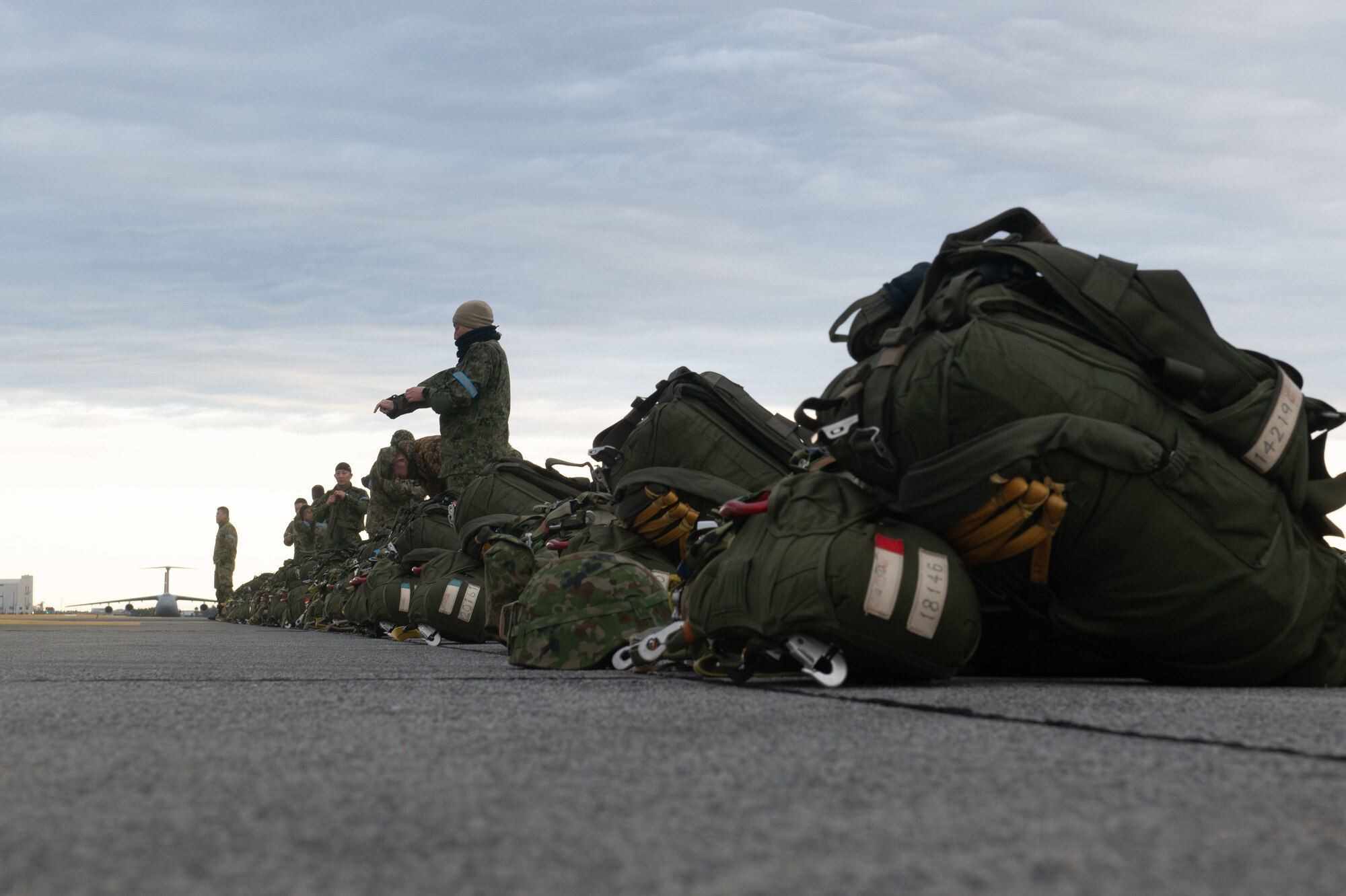 Paratroopers prepare to load onto a C-130J for static-line jump training during Airborne 24
