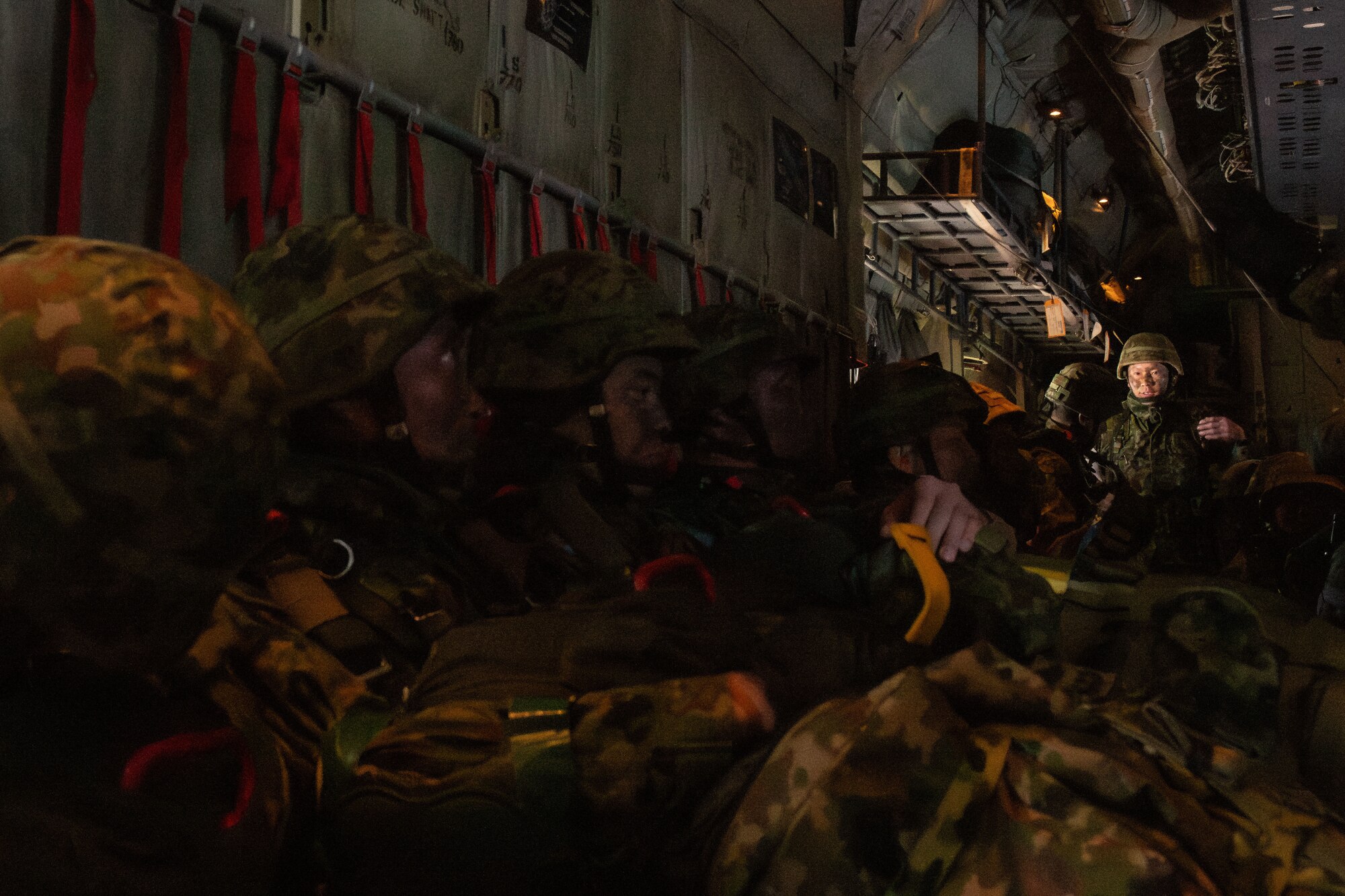 Paratroopers wait for further instruction inside of a C-130J during Airborne 24.