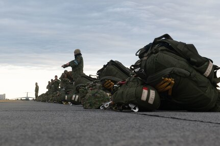 Paratroopers prepare to load onto a C-130J for static-line jump training during Airborne 24