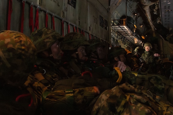 Paratroopers wait for further instruction inside of a C-130J during Airborne 24.