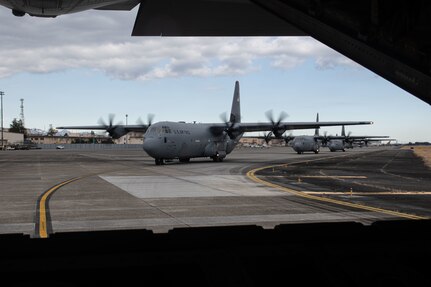 Six C-130Js taxi on the flightline to conduct training operations for static-line jump training during Airborne 24