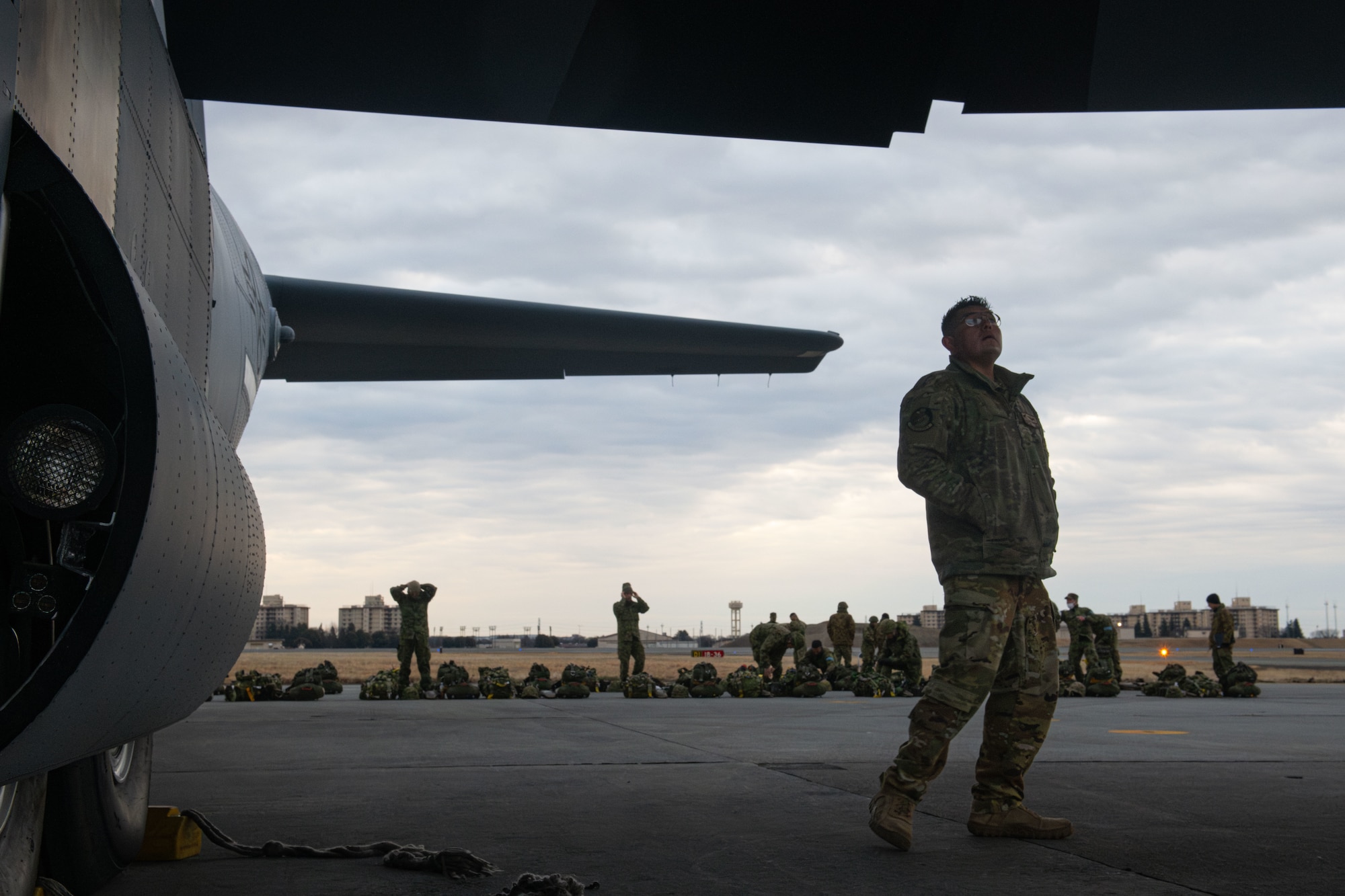 A loadmaster performs a pre-flight inspection on a C-130J during Airborne 24.