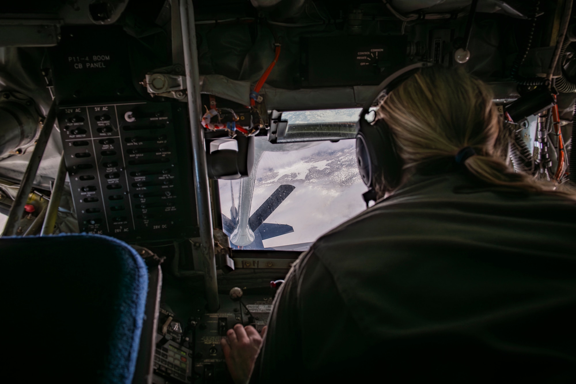 Master Sgt. Brittany Garland, an aerial refueling boom operator with the 370th Flight Test Squadron, operates the aerial refueling boom on a KC-135 Stratotanker during aerial refueling operations in the skies above Edwards Air Force Base, California, Jan. 22, 2024. (Air Force photo by Giancarlo Casem)