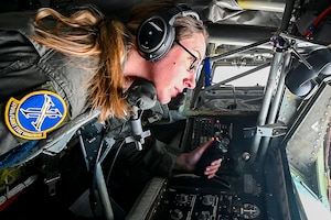 Master Sgt. Brittany Garland, an aerial refueling boom operator with the 370th Flight Test Squadron, operates the aerial refueling boom on a KC-135 Stratotanker during aerial refueling operations in the skies above Edwards Air Force Base, California, Jan. 22, 2024. (Air Force photo by Giancarlo Casem)
