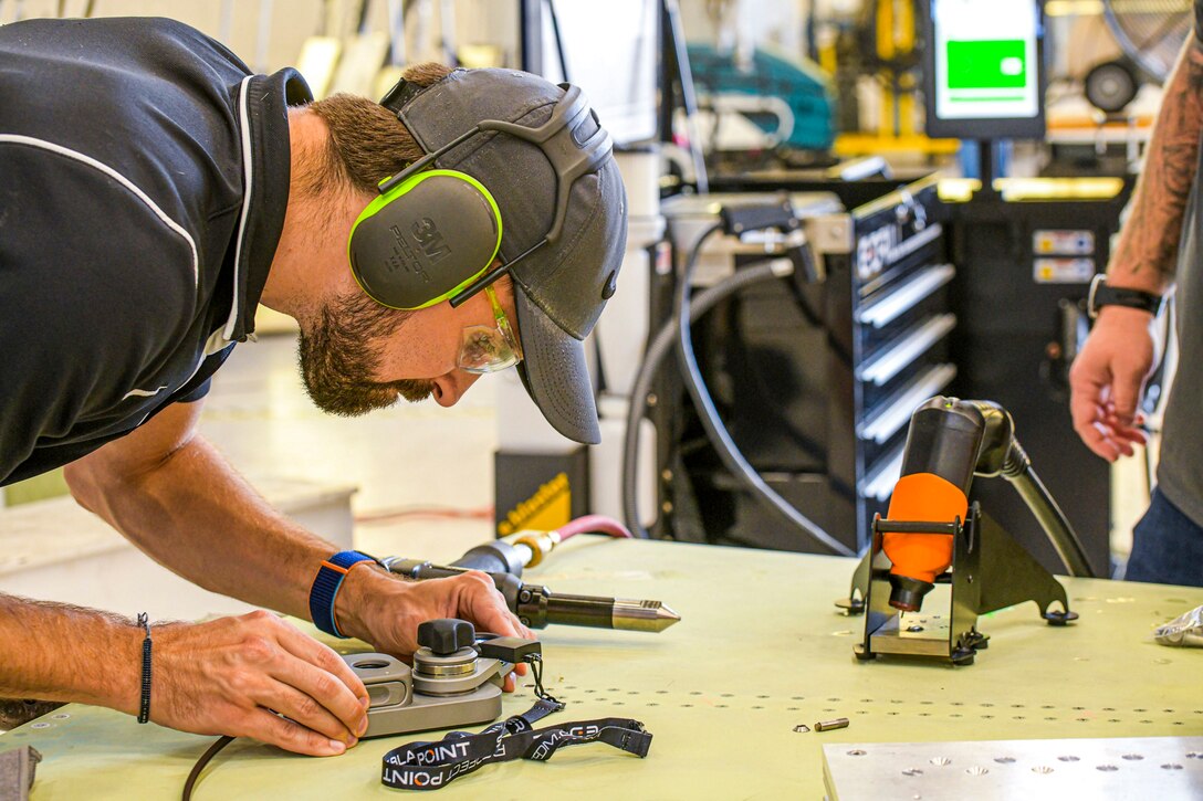 230726-N-DG679-1024
JACKSONVILLE, Fla. (July 26, 2023) 
Charles Newton, a senior materials engineer with Fleet Readiness Center Southeast (FRCSE), uses an E-Drill system to remove fasteners on an F-5 Tiger II horizontal stabilizer. FRCSE’s F-5 Production Line is the first to implement the E-Drill within the NAVAIR enterprise. The device will significantly reduce the time it takes to remove the thousands of rivets typically replaced during in-depth depot-level maintenance. (U.S. Navy Photo by Toiete Jackson/Release)
