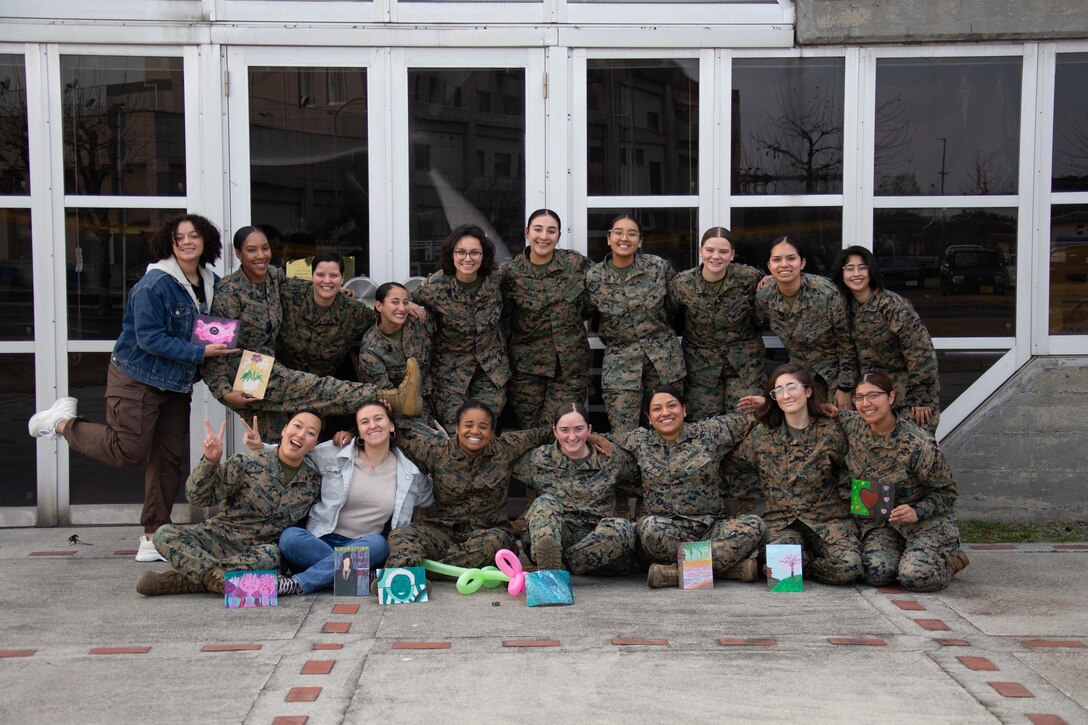 U.S. Marines with Headquarters and Headquarters Squadron, Marine Corps Air Station Iwakuni, take a group photo after the completion of a women's history month professional military education event at MCAS Iwakuni, Japan, March 8, 2024. The professional military education event provided the women of MCAS Iwakuni Headquarters and Headquarters Squadron a time to support each other and learn from Marines past and present. (U.S. Marine Corps photos by Lance Cpl. Brian Long)
