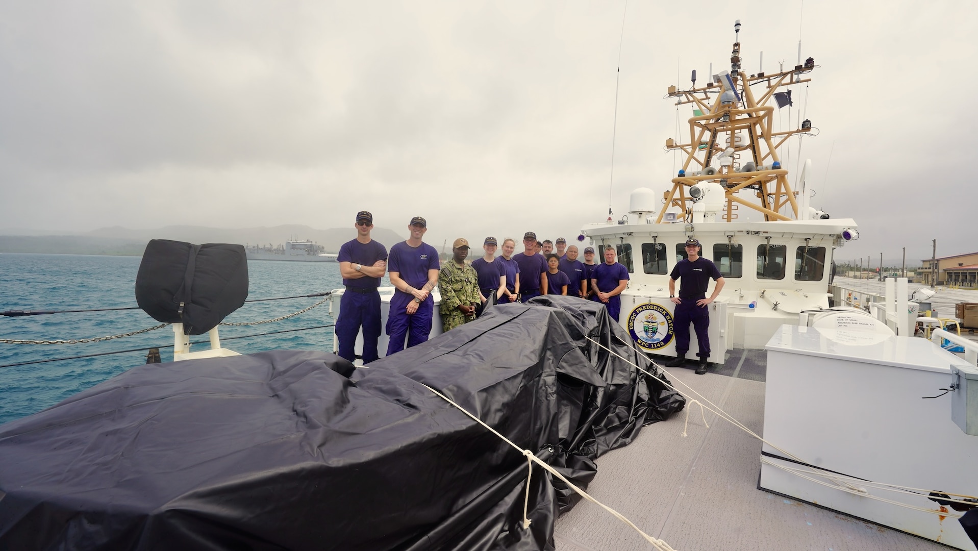 The crew of the USCGC Frederick Hatch (WPC 1143) stand for a photo in port in Guam on Feb. 18, 2024, with 1,500 lbs. of non-perishable food, 1,200 lbs. of water, and essential supplies, including fishing gear and tools, for Ulithi Atoll, FSM, during a state-declared emergency drought. The crew completed a significant operational patrol under Operation Rematau from Feb. 15 to March 4, 2024, reinforcing the U.S. Coast Guard's commitment to maritime safety, security, and environmental stewardship in the Pacific region. (U.S. Coast Guard photo by Chief Warrant Officer Sara Muir)