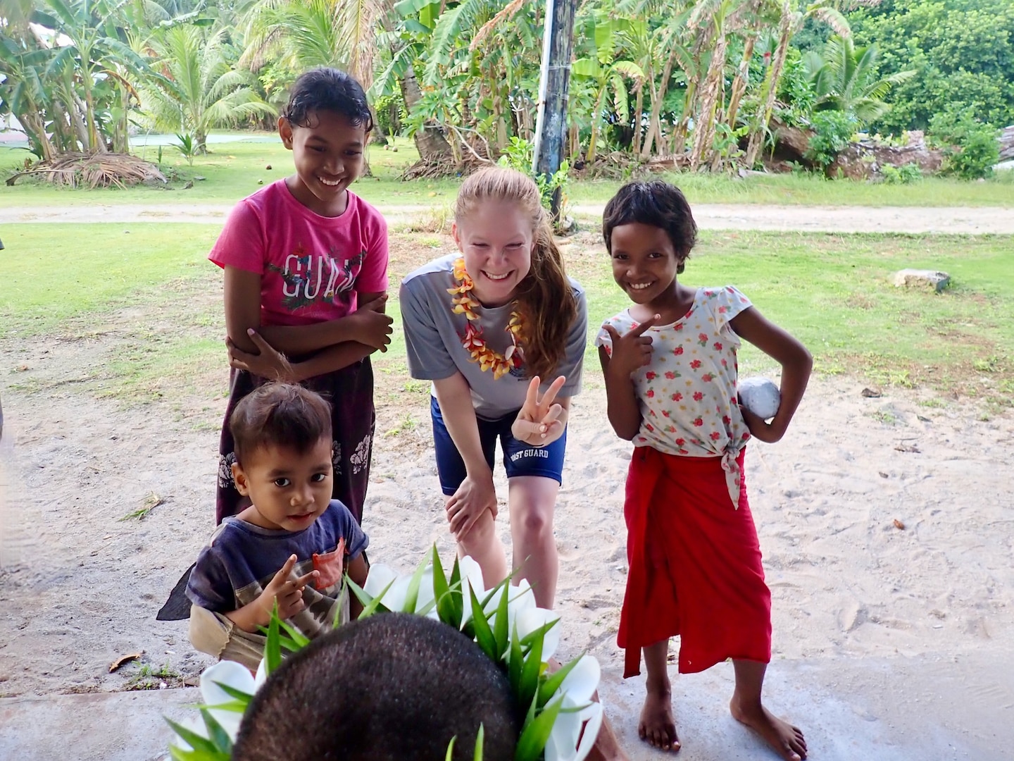 Lt. j.g. Mary Sims, of the USCGC Frederick Hatch (WPC 1143) crew, takes a photo with children on Ulithi Atoll on Feb. 21, 2024. The crew completed a significant operational patrol under Operation Rematau from Feb. 15 to March 4, 2024, reinforcing the U.S. Coast Guard's commitment to maritime safety, security, and environmental stewardship in the Pacific region. (U.S. Coast Guard photo)