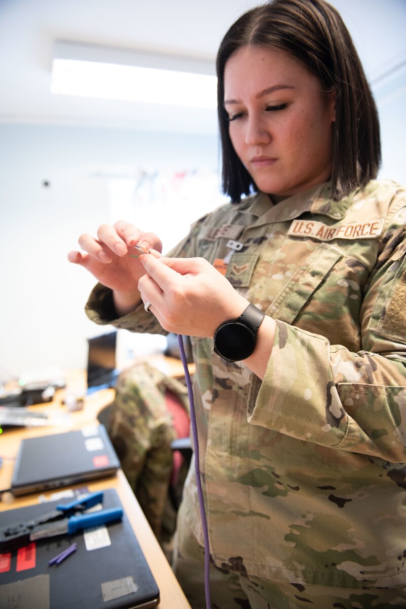 Airman 1st Class Rachel Levere, a 1st Combat Communications cyber systems operator, crimps category 5 cable for a NATO communications system at Luleå-Kallax Air Base, Sweden, March 5, 2024. The 1st CBCS is supporting the 914th Air Refueling Wing during Exercise Nordic Response. NR24 provides vital opportunities for U.S. active-duty personnel, reservists, and ANG members to integrate and train alongside NATO Allies to ensure interoperability. (U.S. Air Force Photo by Senior Master Sgt. Andrew Caya)