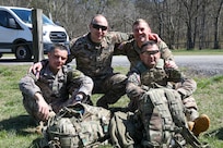 Georgia Defense Force Junior Sergeant Paata Sabiashvili, front left, an infantryman representing the 1st Infantry Brigade; Georgia Defense Force Corporal-Specialist Irakli Nozadze, front right, a cannon crewmember representing the 5th Artillery Brigade; 1st Sgt. Sergo Kandelaki, back left, executive assistant to the Georgia Defense Force Command Sergeant Major, Georgia Defense Force General Staff; and Staff Sgt. Michael Tenoshcok, back right, Joint Operation Center noncommissioned officer, Joint Force Headquarters, Georgia National Guard; pose for a photo during the 2024 Georgia Army National Guard State Best Warrior Competition at the Catoosa Volunteer Training Site, Ringgold, Georgia, March 12, 2024.