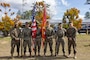 U.S. Marine Corps Master Gunnery Sgt. Eddie W. Dowdell III, outgoing sergeant major, and Sgt. Maj. Casey S. Chandler, incoming sergeant major, both with 2nd Network Battalion, pose for a photo with the 2nd Network Battalion color guard, after a relief and appointment ceremony on Marine Corps Base Camp Lejeune, North Carolina, March 8, 2024. Dowdell relinquished his post as the senior enlisted advisor to Chandler. (U.S. Marine Corps photo by Lance Cpl. Alyssa J. Deputee)