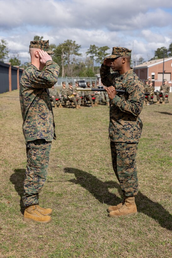 U.S. Marine Corps Master Gunnery Sgt. Eddie W. Dowdell III, right, outgoing sergeant major of 2nd Network Battalion, renders a salute to Lt. Col. Andrew S. Walker, commanding officer, 2nd Network Battalion, during a relief and appointment ceremony on Marine Corps Base Camp Lejeune, North Carolina, March 8, 2024. Dowdell relinquished his post as the senior enlisted advisor to Sgt. Maj. Casey S. Chandler, incoming sergeant major of 2nd Network Battalion. (U.S. Marine Corps photo by Lance Cpl. Alyssa J. Deputee)