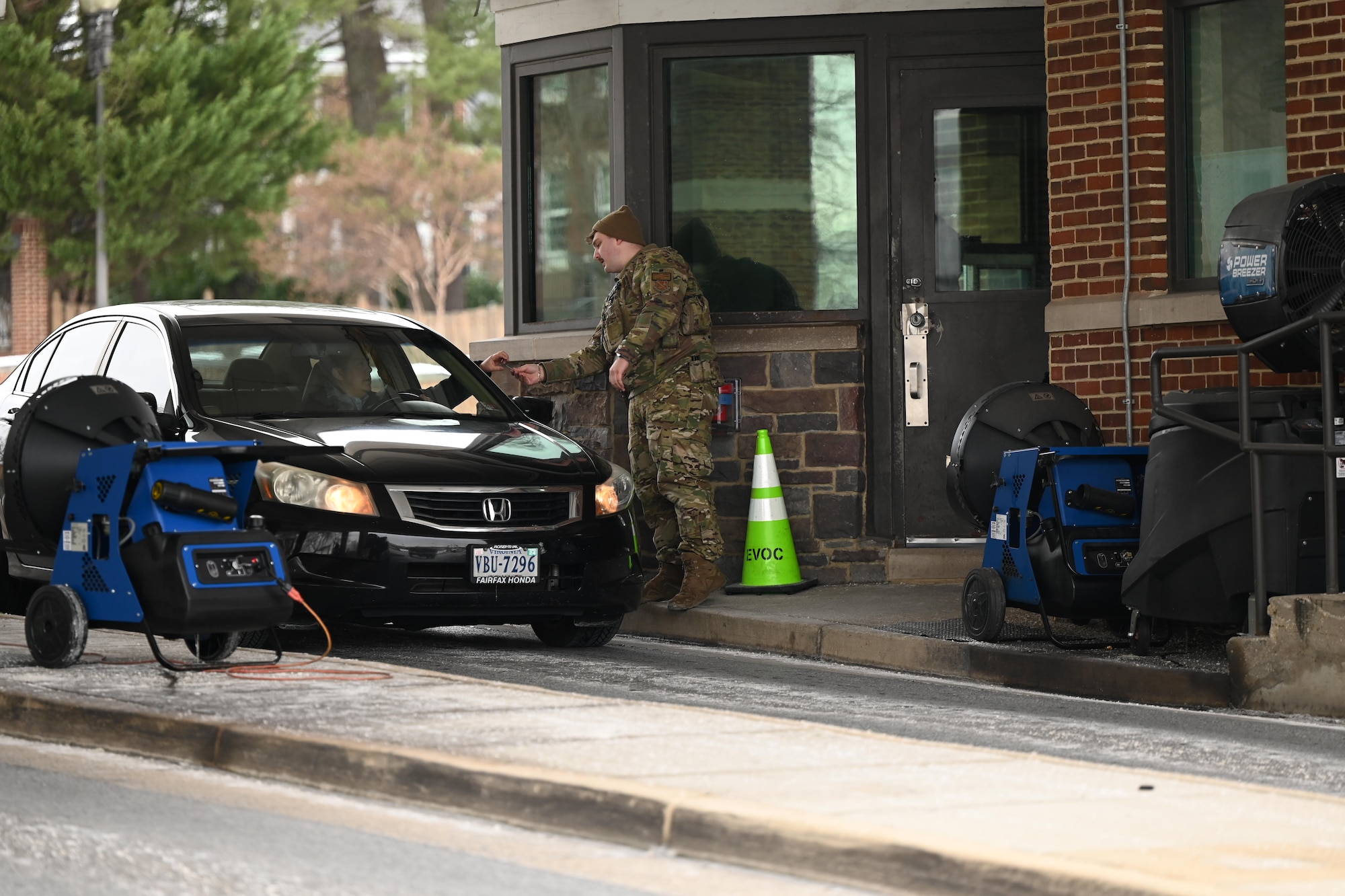 U.S. Air Force Senior Airman William Dyer, a gate guard with the 11th Security Forces Squadron, checks driver credentials at Arnold Gate on Joint Base Anacostia-Bolling, Washington, D.C., on Jan. 18, 2024.