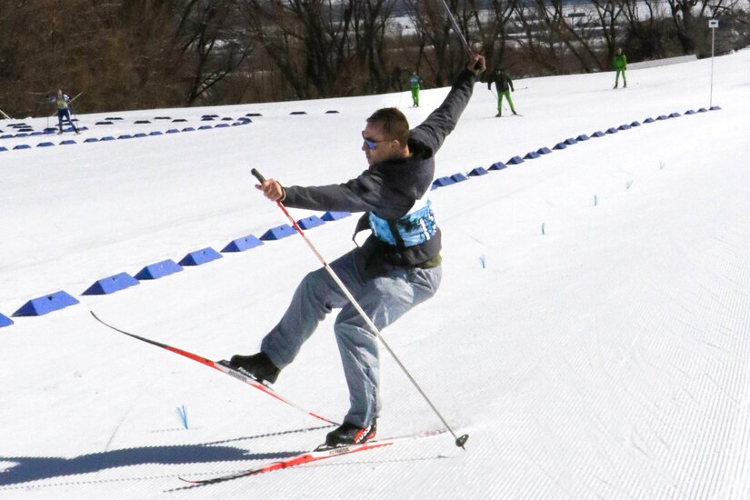 Sgt. Gavin Hutchinson, from the Pennsylvania National Guard finishes the Sprint Race with flair at the 50th anniversary Chief of the National Guard Bureau Biathlon Championships at Soldier Hollow Nordic Center, Feb. 17, 2024. The Utah National Guard hosted the national biathlon competition consisting of cross-country skiing and competitive shooting events that test the warriors’ endurance and marksmanship.