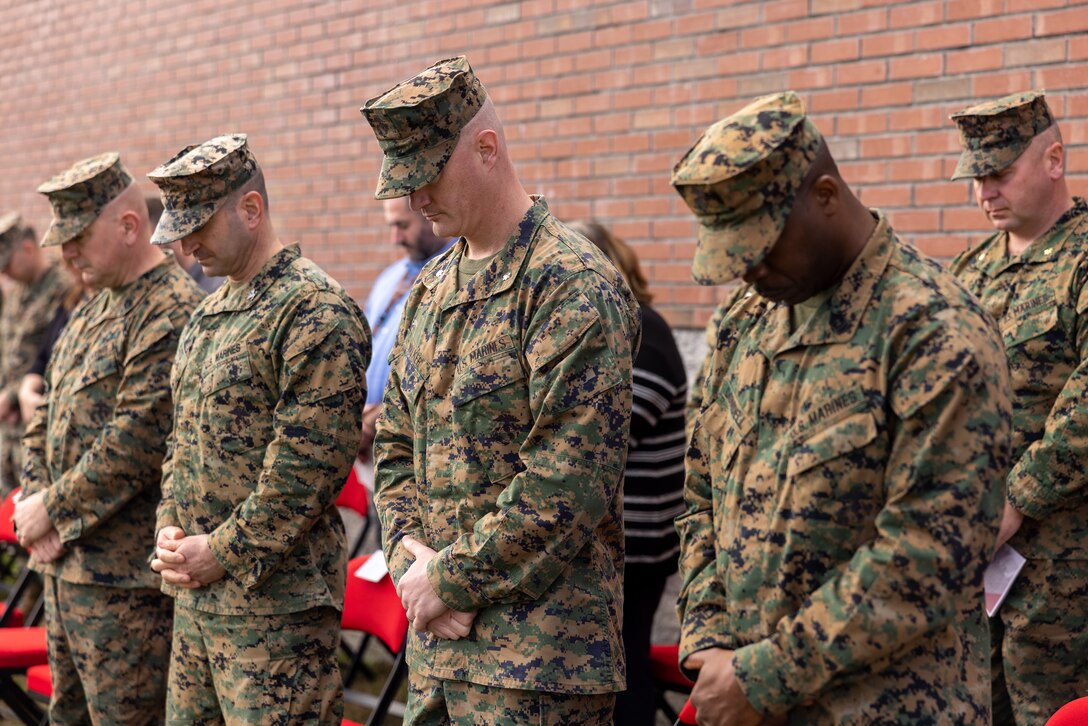 U.S. Marine Leaders with 2nd Network Battalion bow their heads during the invocation as a relief and appointment ceremony begins on Marine Corps Base Camp Lejeune, North Carolina, March 8, 2024.