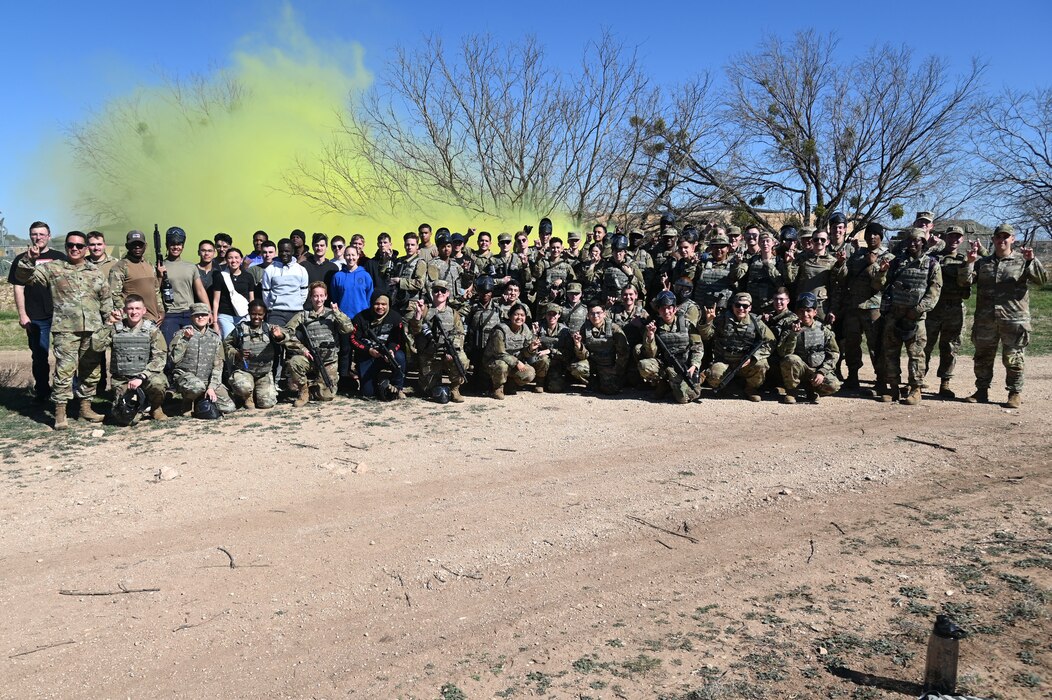 Cadets and staff from Angelo State University Air Force ROTC and training personnel assigned to Goodfellow Air Force Base pose for a group photo at the conclusion of the annual ROTC field training exercise at Goodfellow AFB, Texas, March 1, 2024. Cadets practiced expeditionary skills with paintball guns as part of the field training exercise. (U.S. Air Force Photo by Airman James Salellas)