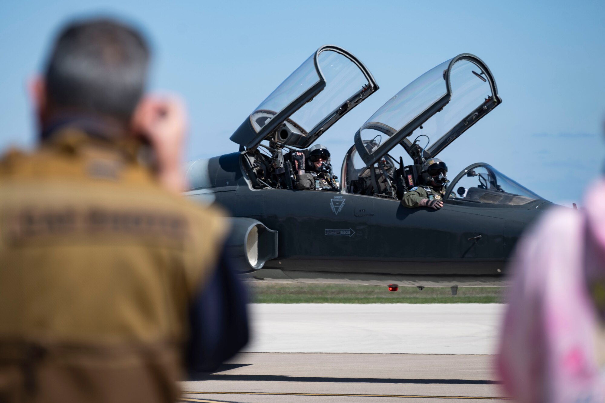 two t-38 pilots taxxing down the runway