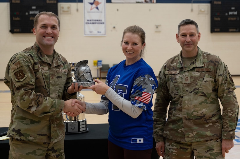 JBLE Commander and Command Chief give award to Lt. Col. Debra Maloney-Ramos