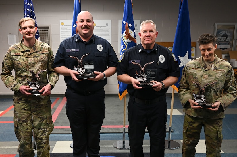 Four members of the 11th Security Forces Squadron pose with their Air Force District of Washington Outstanding Security Forces individual awards on Joint Base Anacostia-Bolling, Washington, D.C., March 12, 2024. From the left: U.S. Air Force Tech. Sgt. Kristopher Wayne, noncommissioned officer in charge of operations; police Sgt. Dylan Myers, Alpha flight sergeant; police Sgt. 1st Class Robert Cox, Alpha flight chief; and U.S. Air Force Master Sgt. Melinda Miller, Charlie flight chief, were recognized for their significant contributions to the Security Forces career field.