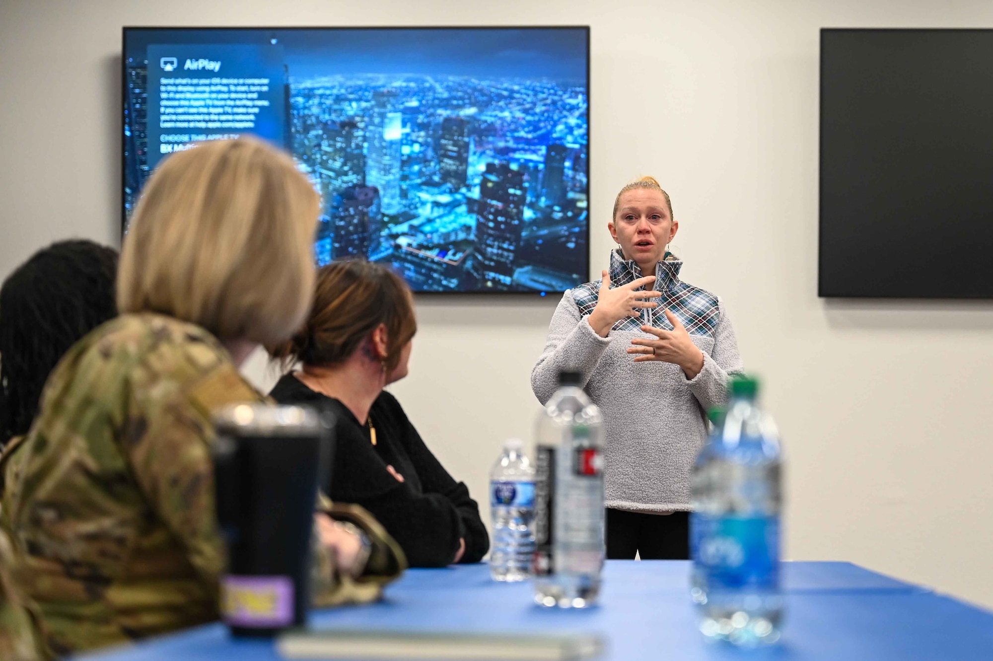 Nicole Valence, 97th Air Mobility Wing community engagement chief, thanks the women on the panel for being honest about their experiences during Coffee and Connect at Altus Air Force Base, Oklahoma, March 6, 2024. Valence is one of the organizers of Coffee and Connect. (U.S. Air Force photo by Airman 1st Class Kari Degraffenreed)