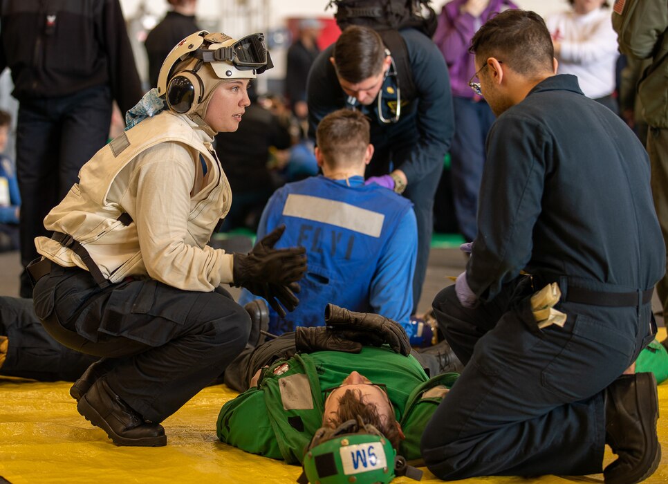 240219-N-JD579-1058 Hospital Corpsman 3rd Class Kasey R. Reynolds, left, from Reno, Nevada, assigned to Helicopter Sea Combat Squadron (HSC) 5, assists patients aboard Nimitz-class aircraft carrier USS George Washington (CVN 73) during a mass casualty drill while underway in the Atlantic Ocean, Feb. 19, 2024. George Washington is conducting Tailored Ships Training Availability and Final Evaluation Problem (TSTA/FEP). TSTA prepares the ship and crew for full integration into a carrier strike group through a wide range of mission critical operations. (U.S. Navy photo by Mass Communication Specialist 2nd Class John T. Jarrett)