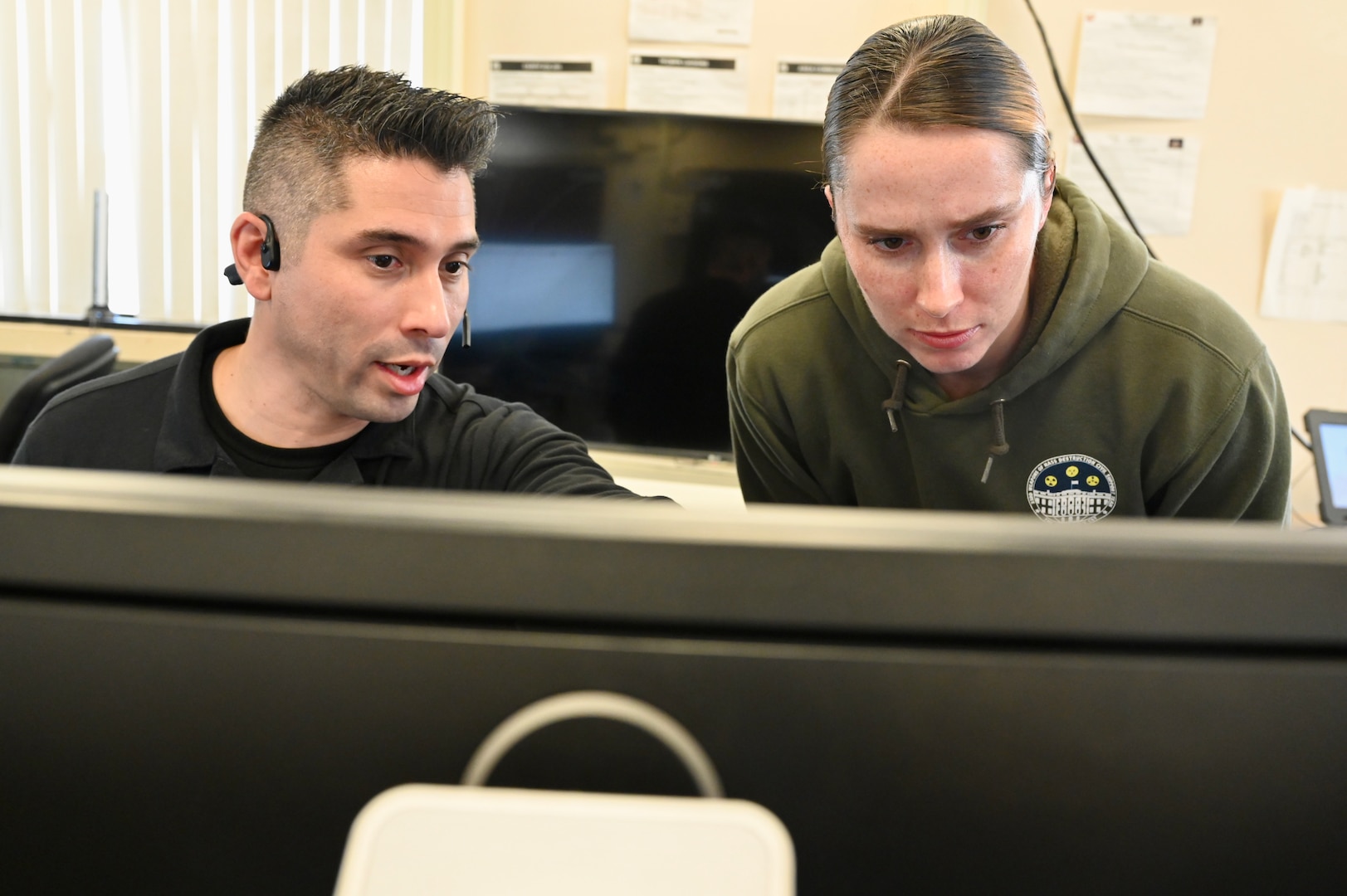 U.S. Army Sgt. 1st Class Daniel Garcia, operations noncommissioned officer and GIS modeler, 33rd WMD-CST, and U.S. Army Staff Sgt. Chasity Townsend, administration noncommissioned officer, 33rd WMD-CST, review a plan at the D.C. Armory, March 7, 2024.  The 33rd WMD-CST was strategically positioned to respond effectively with D.C. Fire, U.S. Secret Service, U.S. Capitol Police, and CBRNE Enhanced Response Force Packages (CERFP) units.