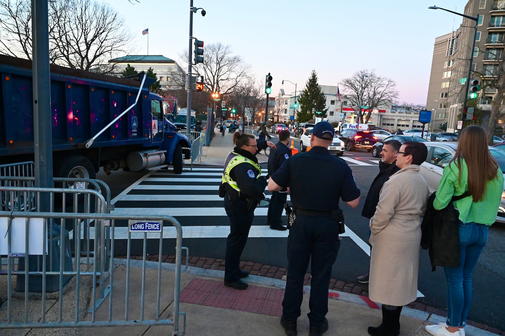 Pedestrians gather near a road closure in Washington, D.C., March 7, 2024.  The 33rd WMD-CST was strategically positioned to respond effectively with D.C. Fire, U.S. Secret Service, U.S. Capitol Police, and CBRNE Enhanced Response Force Packages (CERFP) units.