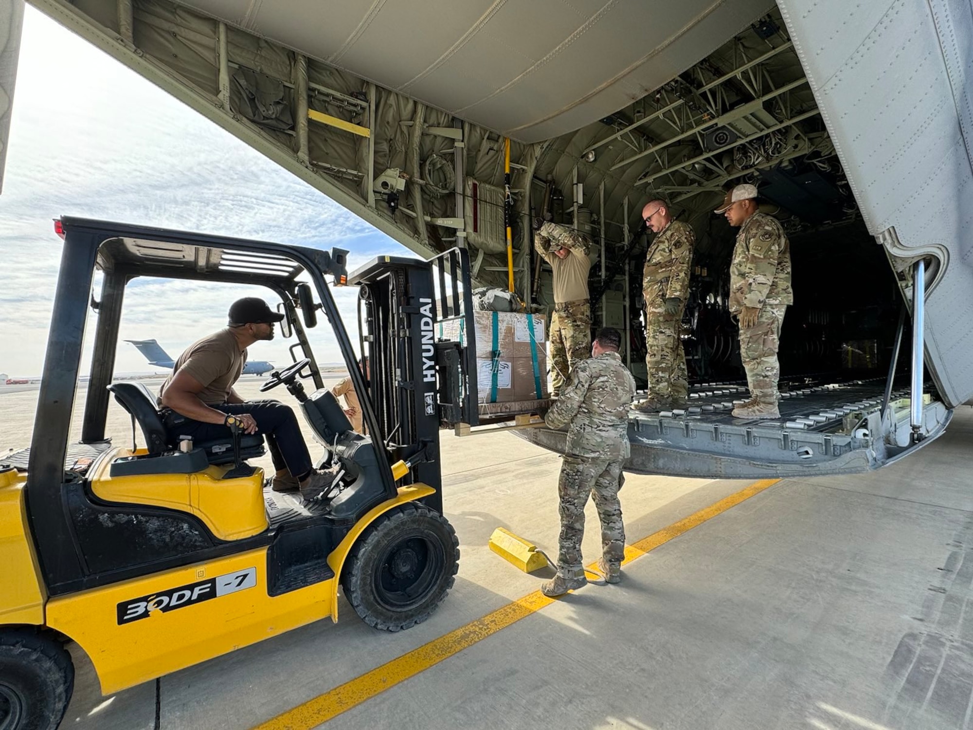 Airmen load humanitarian aid destined for airdrop over Gaza.