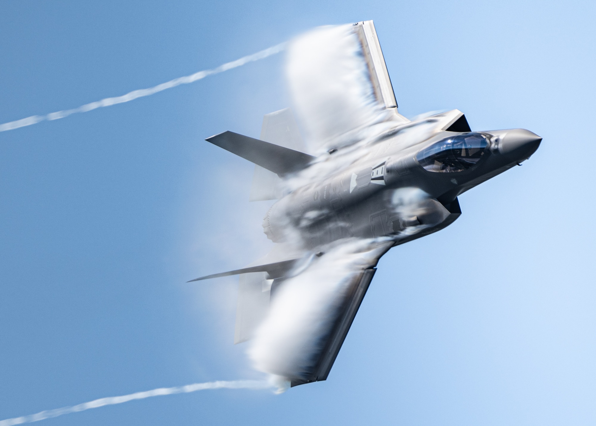 An F-35A Lightning II flown by Maj. Kristin "BEO" Wolfe, who is assigned to the 388th Fighter Wing, at Hill Air Force Base, UT, performs a dedication pass during an airshow on Sept 8, 2023, over Kleine Brogel Air Base, Belgium.