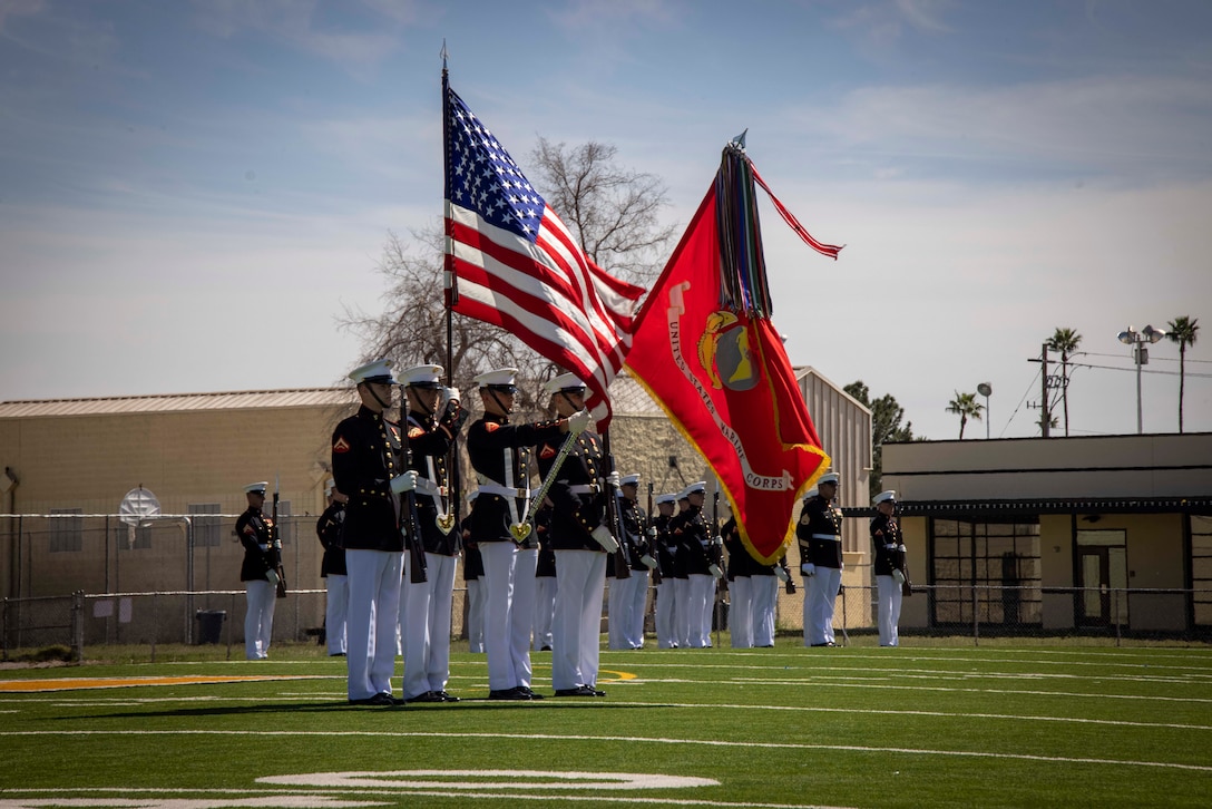 Marines with the Official U.S. Marine Corps Color Guard present the U.S. flag during a performance at Maryvale High School, Phoenix, Ariz., Mar. 5 , 2024. The Battle Color Detachment will finish the last leg of their west coast tour in Albuquerque, NM. (U.S. Marine Corps photo by Lance Cpl. Chloe N. McAfee)