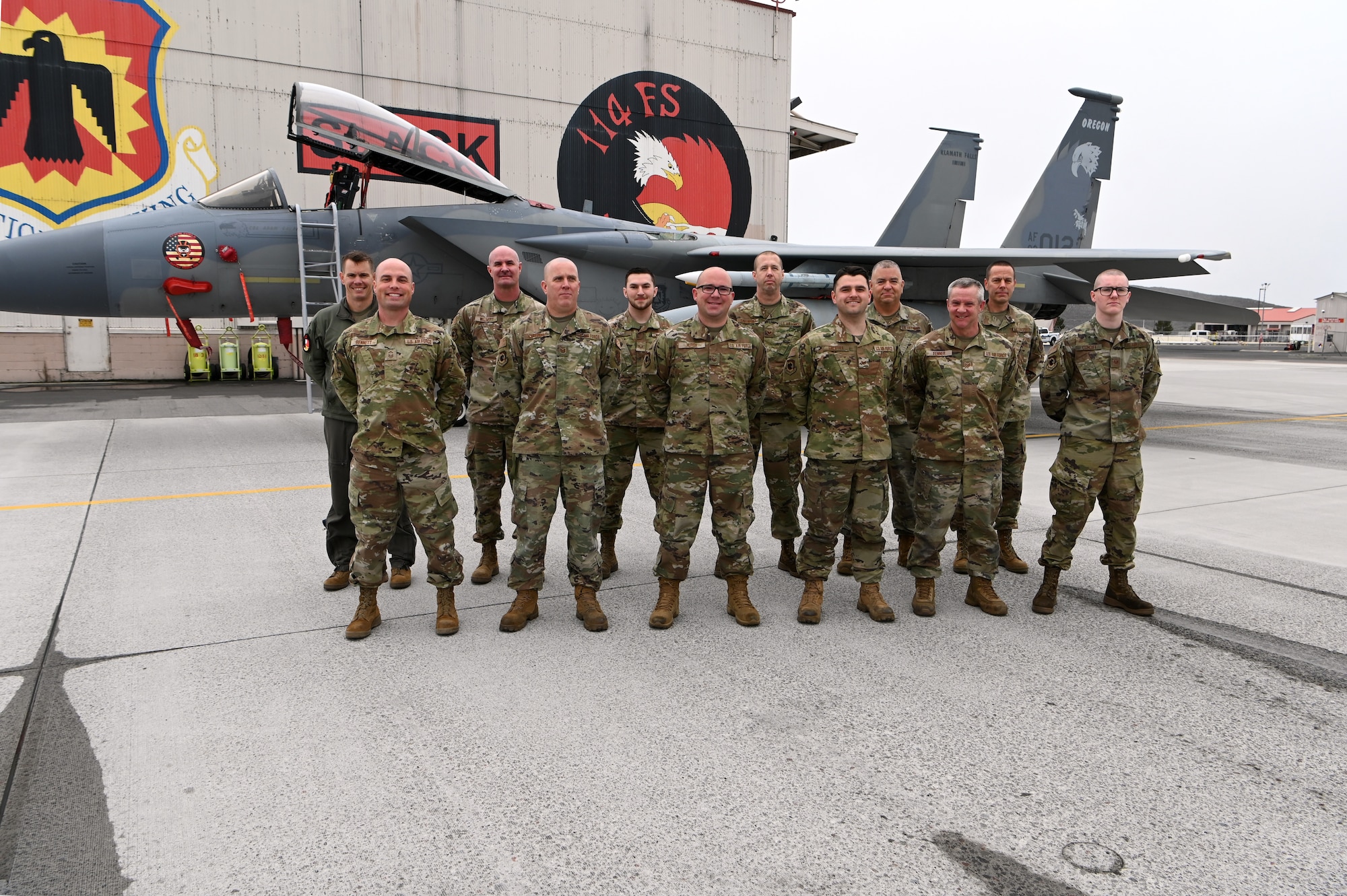 group of Airmen in front of F-15 Eagle