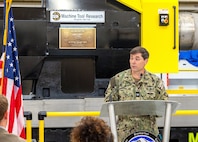 Capt. JD Crinklaw, commander, Puget Sound Naval Shipyard & Intermediate Maintenance Facility in Bremerton, Washington, delivers remarks, Feb. 26, 2024, during a dedication ceremony for a new propulsion shaft lathe, honoring Special Warfare Operator 1st Class (Navy SEAL) Patrick D. Feeks, who was killed in Afghanistan Aug. 16, 2012. (U.S Navy photo by Jeb Fach)