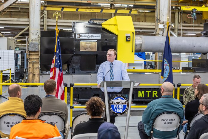 Mike Jepson, operations director, Shop 31, Inside Machinist, at Puget Sound Naval Shipyard & Intermediate Maintenance Facility, describes what the new propulsion shaft lathe will mean to the Navy and PSNS & IMF in the years to come, during a dedication ceremony Feb. 26, 2024, in Bremerton, Washington, for a new propulsion shaft lathe, honoring Special Warfare Operator 1st Class (Navy SEAL) Patrick D. Feeks, who was killed in Afghanistan Aug. 16, 2012. (U.S. Navy photo by Jeb Fach)