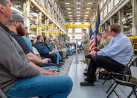 Capt. JD Crinklaw, commander, Puget Sound Naval Shipyard & Intermediate Maintenance Facility in Bremerton, Washington, delivers remarks, Feb. 26, 2024, during a dedication ceremony for a new propulsion shaft lathe, honoring Special Warfare Operator 1st Class (Navy SEAL) Patrick D. Feeks, who was killed in Afghanistan Aug. 16, 2012. (U.S Navy photo by Wendy Hallmark)