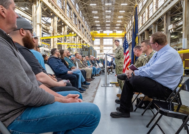 Capt. JD Crinklaw, commander, Puget Sound Naval Shipyard & Intermediate Maintenance Facility in Bremerton, Washington, delivers remarks, Feb. 26, 2024, during a dedication ceremony for a new propulsion shaft lathe, honoring Special Warfare Operator 1st Class (Navy SEAL) Patrick D. Feeks, who was killed in Afghanistan Aug. 16, 2012. (U.S Navy photo by Wendy Hallmark)