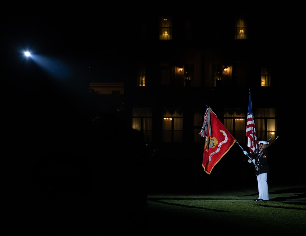 Marines with the Official U.S. Marine Corps Color Guard present the U.S. flag during a Friday Evening Parade at Marine Barracks Washington, D.C., May 19, 2023. The 38th Commandant of the United States Marine Corps, Gen. David H. Berger, was the hosting official and the guests of honor were the Rear Admiral Carey H. Cash, 21st Chaplain of the United States Marine Corps, Rabbi Arnold Resnicoff, retired Navy Chaplain, Reverend Dianna Pohlman-Bell, retired Navy Chaplain, Dr. Mae Pouget, Chaplain Parham’s daughter, and Dr. Thomas Parham III, Chaplain Parham’s son. (U.S. Marine Corps photo by LCpl. Pranav Ramakrishna)