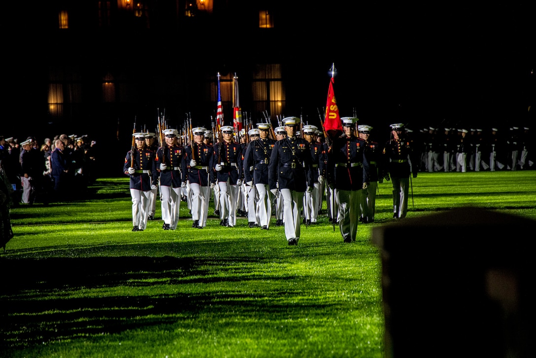 Barracks Marines with Alpha Company, Marine Barracks Washington, execute “pass in review” during a Friday Evening Parade at MBW, Aug. 25, 2023. The hosting official for the evening was Gen. Eric M. Smith, Assistant Commandant of the Marine Corps. The guest of honor was His Excellency Lui Tuck Yew, Ambassador of Singapore to the United States of America. (U.S. Marine Corps photo by Lance Cpl. Chloe N. McAfee)