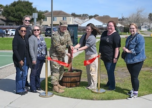 Col. Shoemaker and spouses cut the ribbon to the little library.