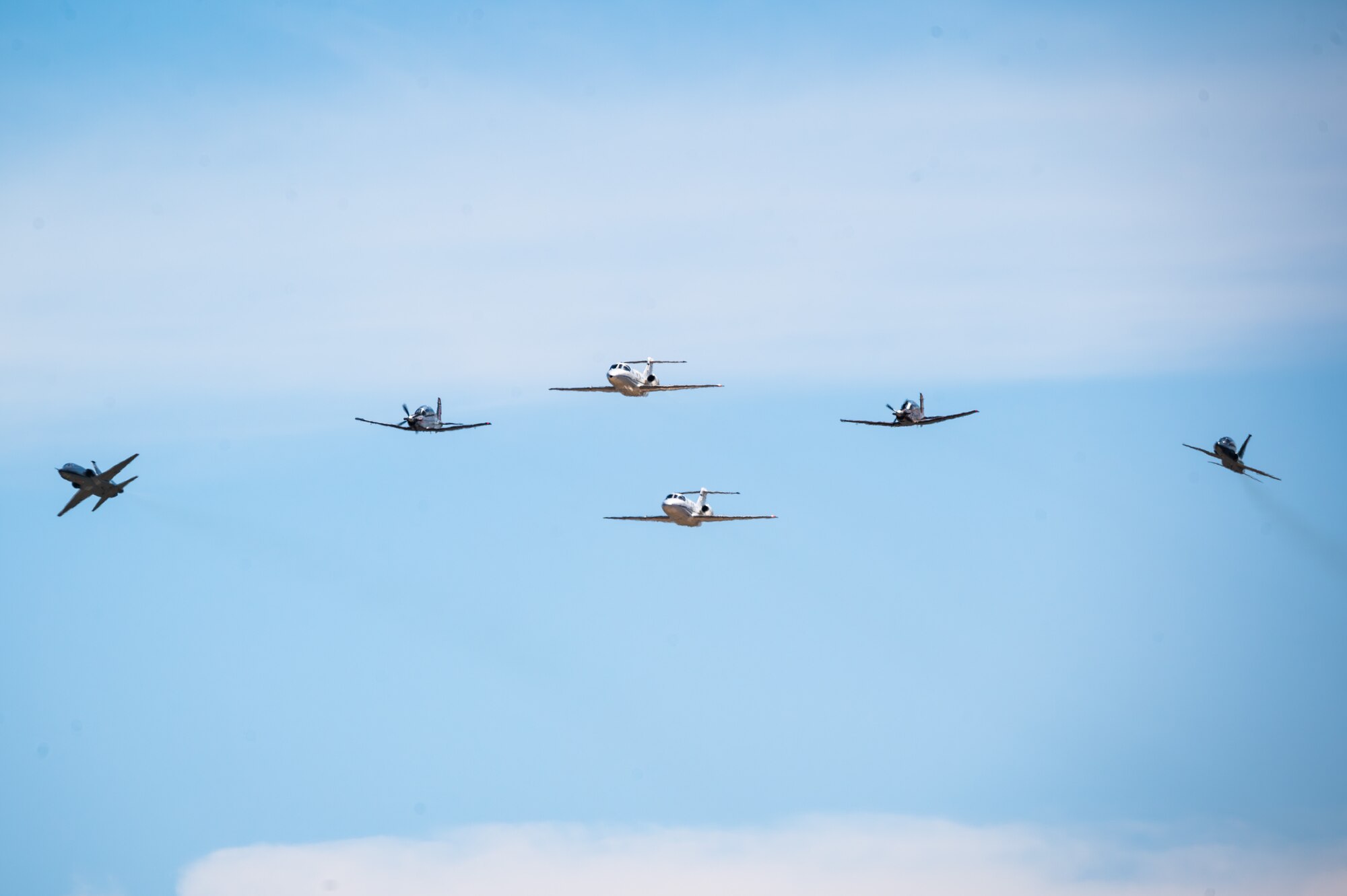 Six U.S. Air Force aircraft perform a dissimilar formation during the Fiesta of Flight airshow at Laughlin Air Force Base, Texas, March 9, 2024. The formation included two T-1A Jayhawks, two T-6A Texan II’s and two T-38C Talons. Approximately 16,000 people attended the Fiesta of Flight 2024. (U.S. Air Force photo by Airman 1st Class Keira Rossman)