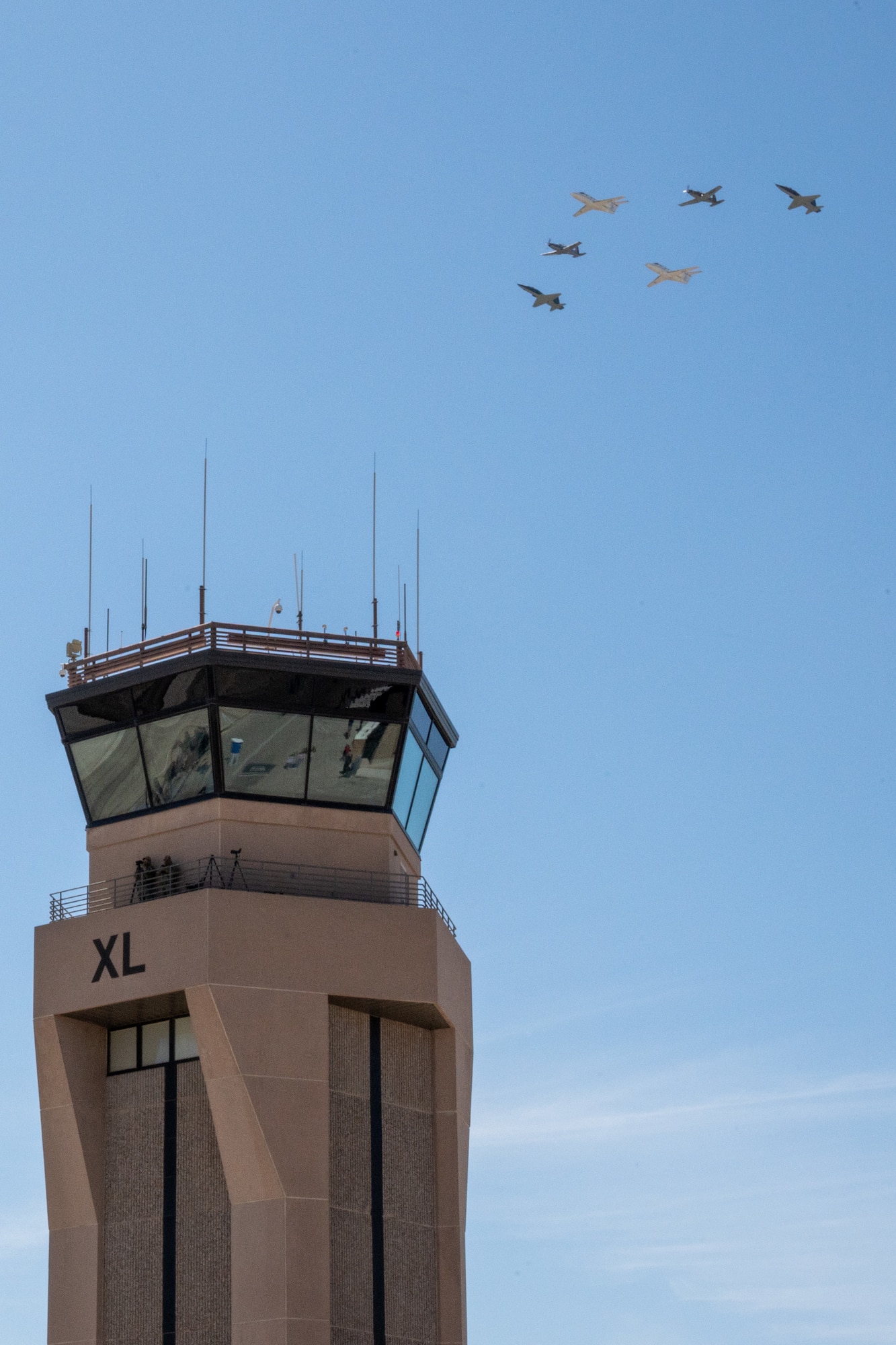 Six U.S. Air Force aircraft perform a flyover near the “XL” air traffic control tower at Laughlin Air Force Base, Texas, March 9, 2024. The formation included two T-1A Jayhawks, two T-6A Texan II’s and two T-38C Talons. The flyover was performed during the Fiesta of Flight airshow at show center following the national anthem. (U.S. Air Force photo by Staff Sgt. Nicholas Larsen)