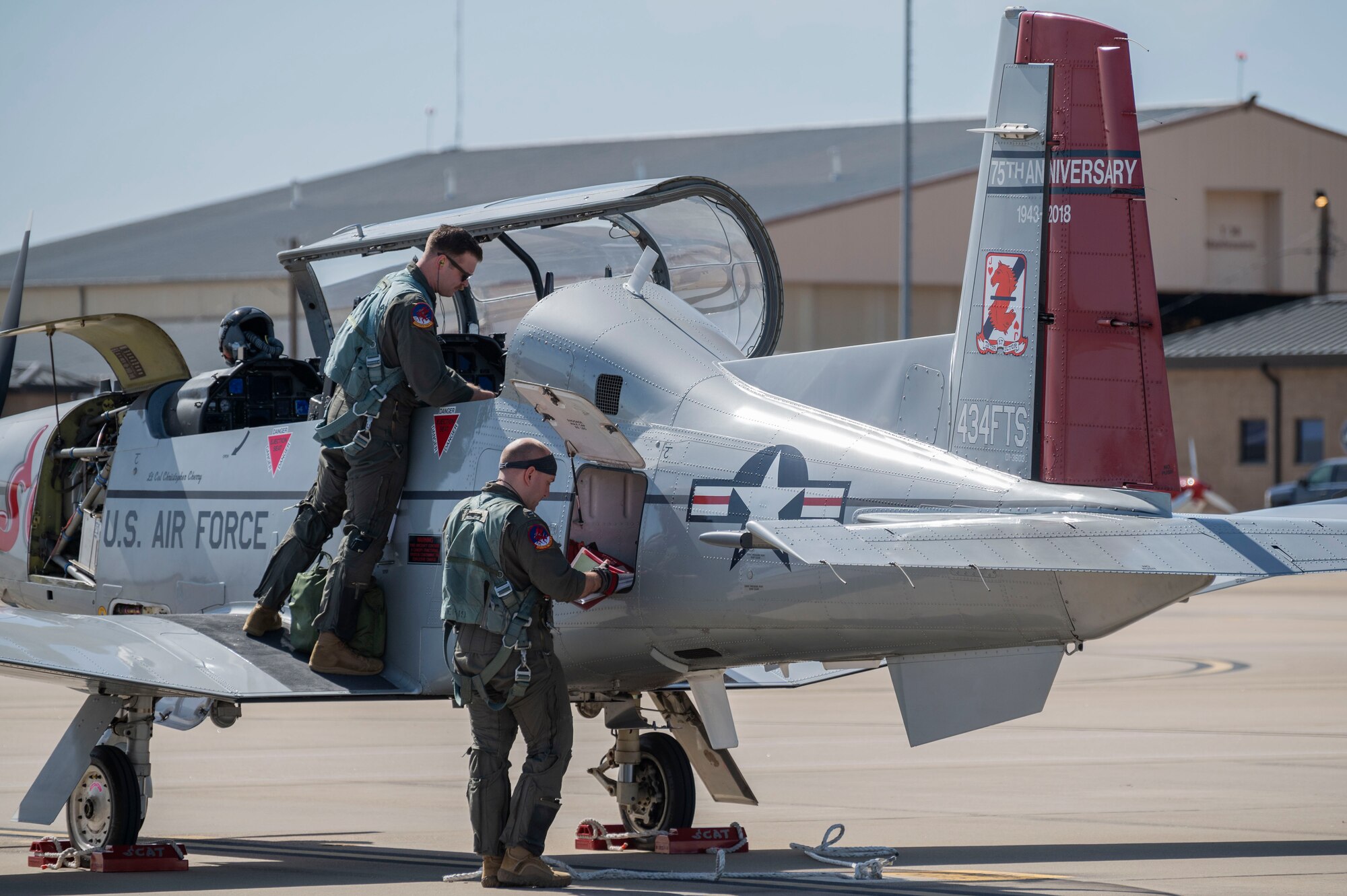 pilots prep a T-6A Texan II aircraft