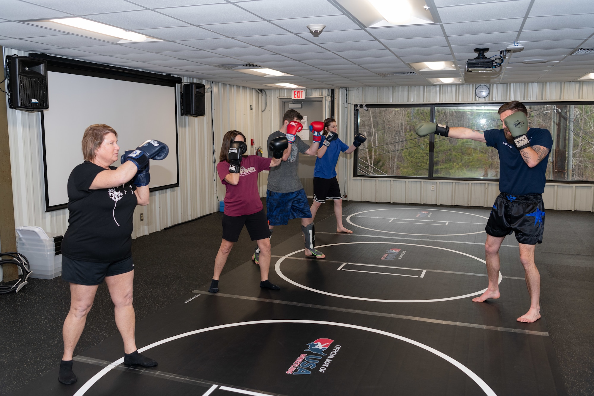 Kickboxing instructor, Ryan Clark, demonstrates movements to class participants at the Fitness Center, Arnold Air Force Base, Tenn., Feb. 8, 2024. The Arnold AFB Fitness Center offers kickboxing classes to its members each Tuesday and Thursday. The center recently celebrated a year of the class that continues to grow in interest with base personnel.