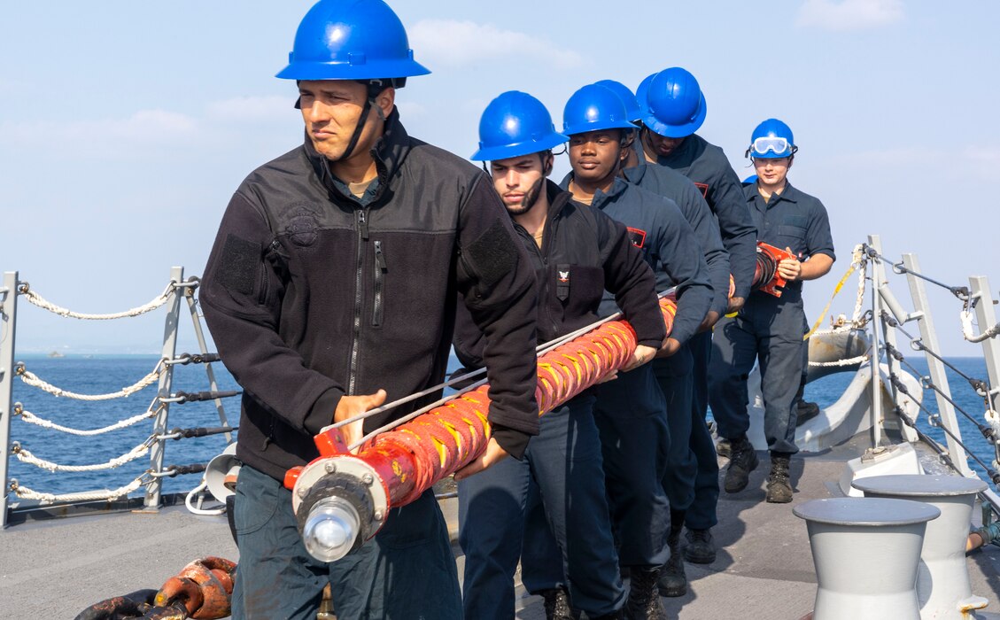 Sailors securing the jackstaff during sea and anchor detail aboard the Arleigh Burke-class guided-missile destroyer USS Rafael Peralta (DDG 115)