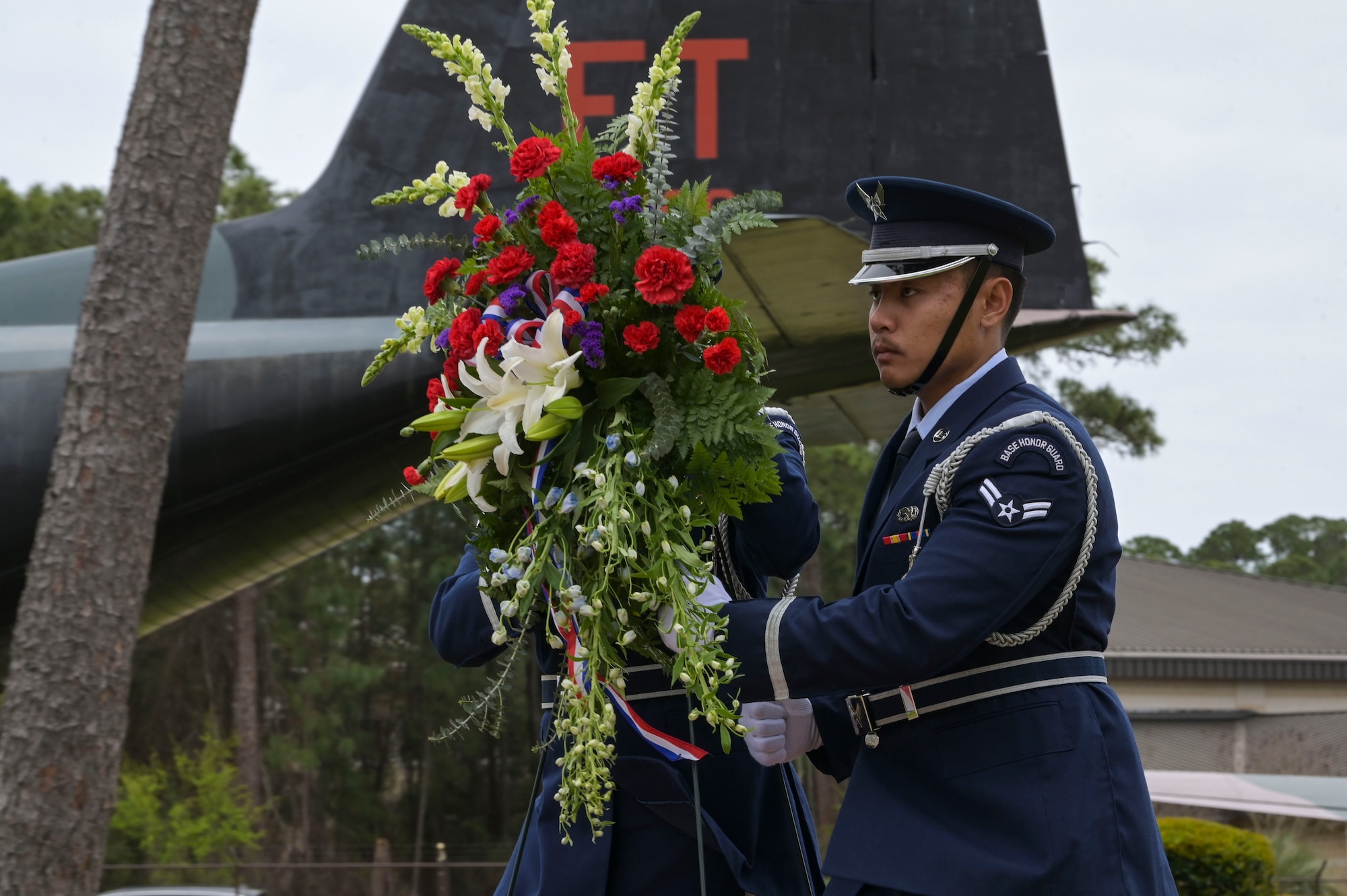 U.S. Air Force Honor Guardsmen, assigned to 1st Special Operations Force Support Squadron, carry a wreath during the Jockey-14 Remembrance Ceremony at Hurlburt Field, Florida, Mar. 14, 2024. The ceremony was held as a reminder of those lost during the Jockey-14 crash, their sacrifices and their families’ enduring sacrifice. (U.S. Air Force photo by Senior Airman Ty Pilgrim)