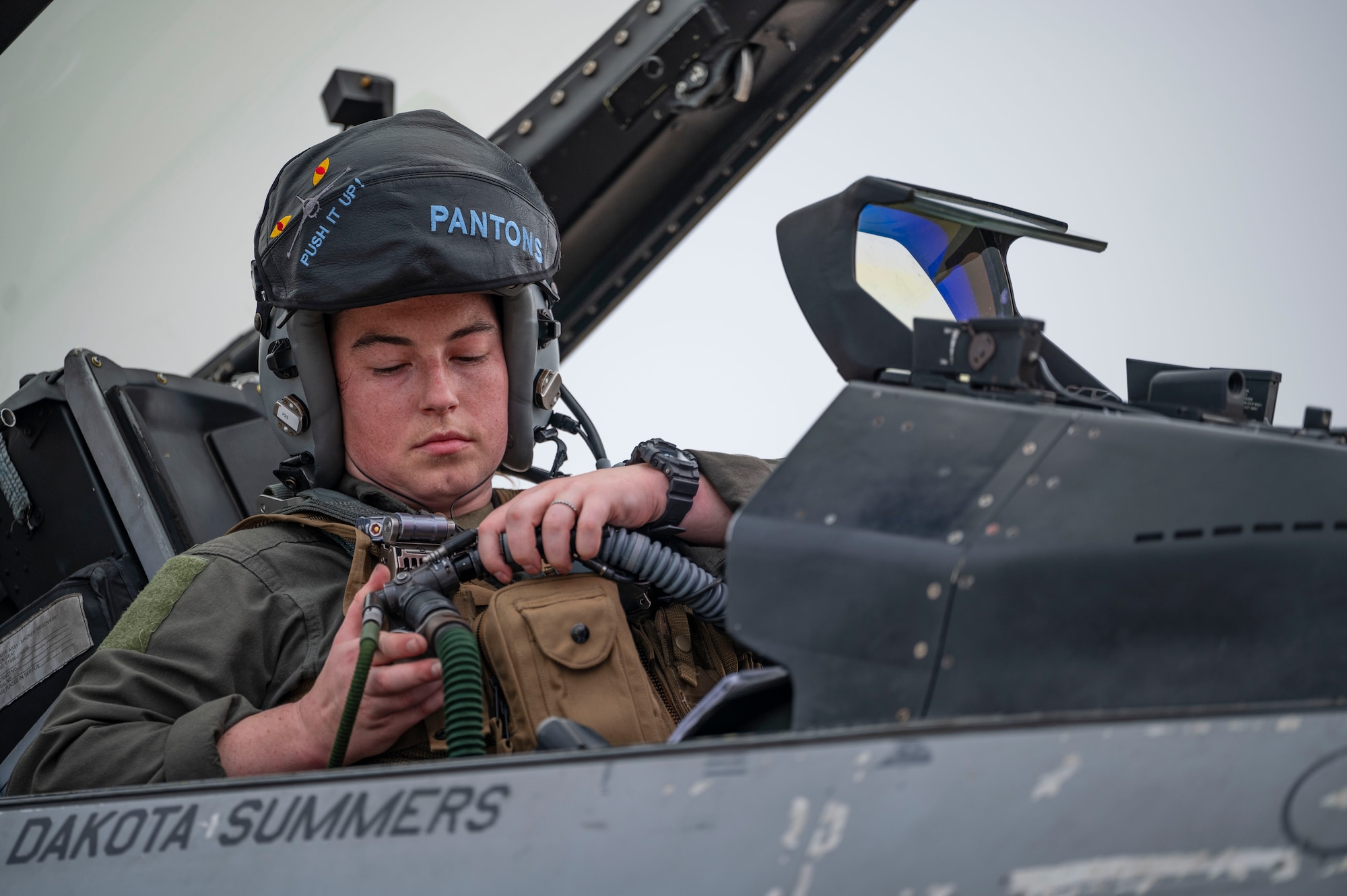 Capt. Sarah Gregory, 35th Fighter Squadron F-16 Fighting Falcon pilot, fastens flight gear before departing for a routine flight